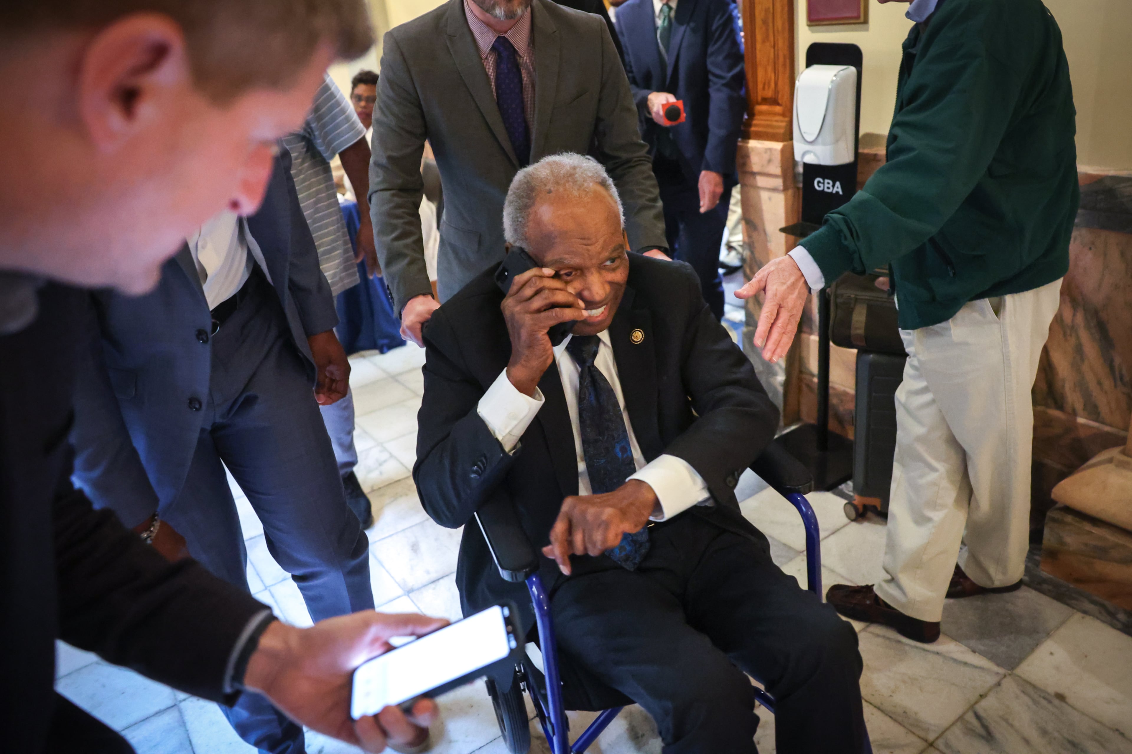 U.S. Rep. David Scott, D-Atlanta, is chased by reporters after filing paperwork to run for reelection at the Capitol. (Arvin Temkar/AJC)