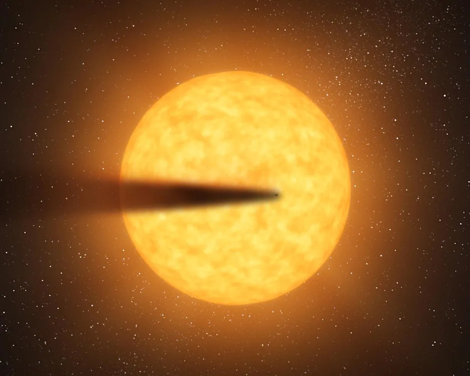 An illustration of a planet streaking to the right from the left, with a large black tail. The planet streaks in front of a glowing yellow ball of light in space