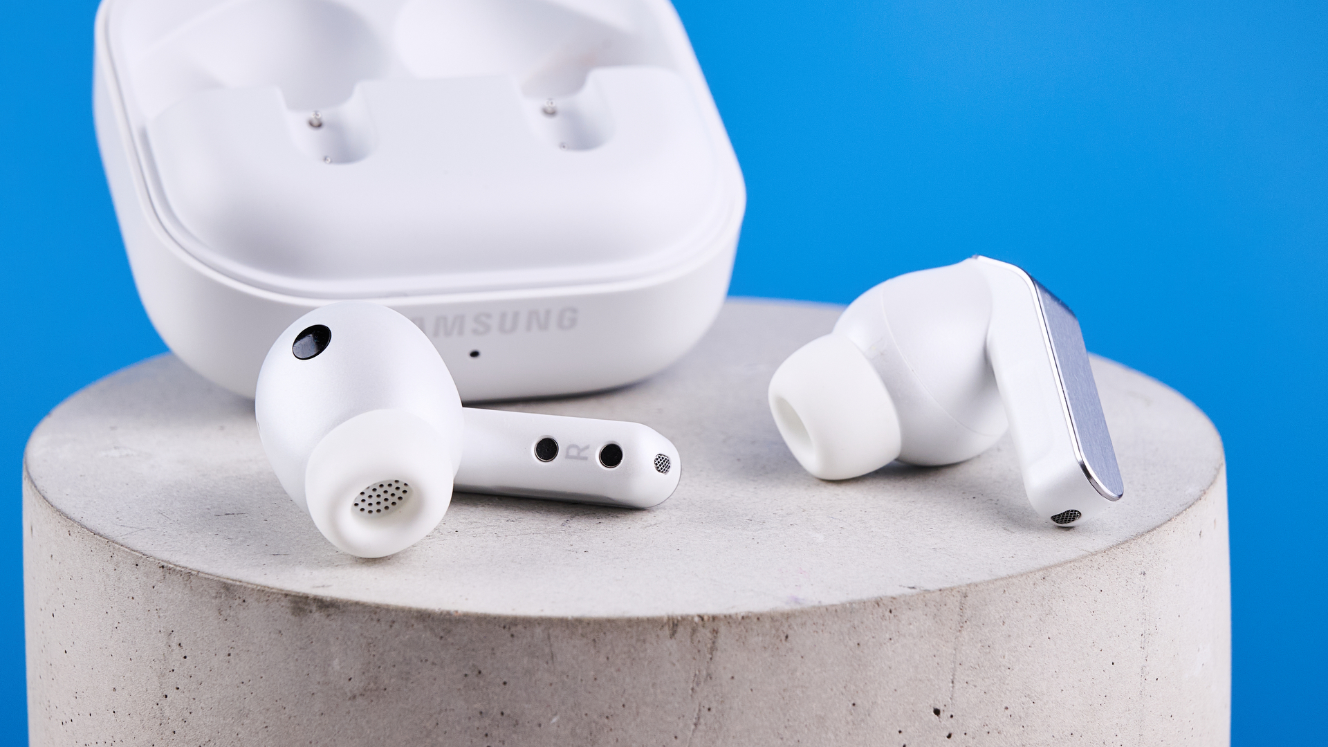 the samsung galaxy buds 4 pro in white photographed against the blue tom's guide background
