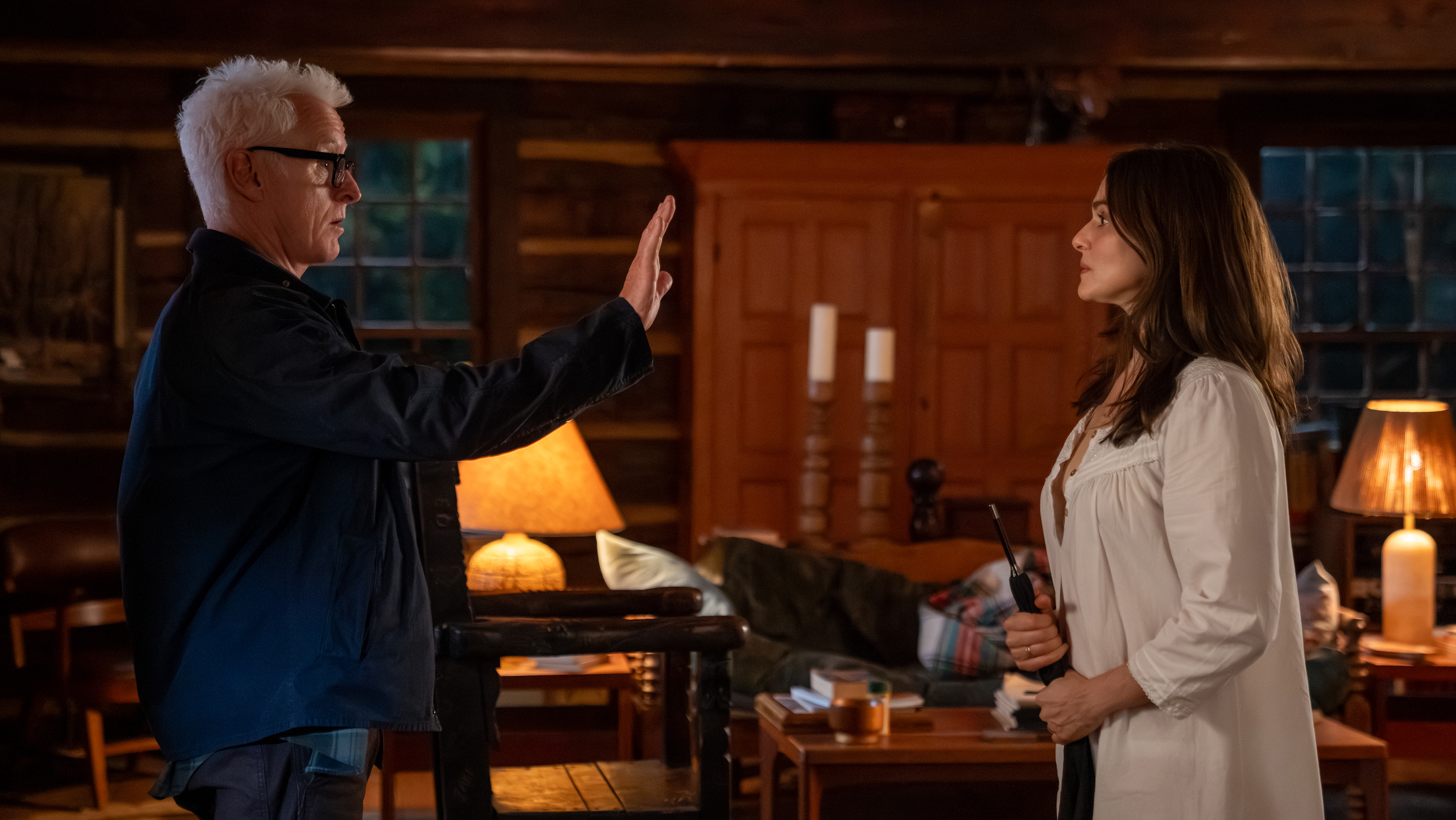 John Slattery as John holding up a hand to signal stop at Rachel Weisz as The Protagonist in their cabin in the final episode of vladimir