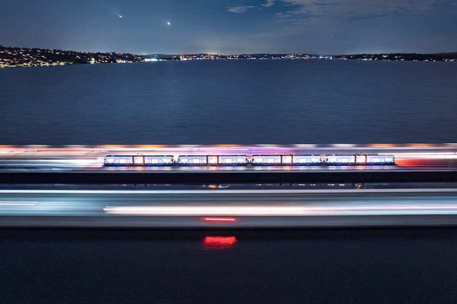 caption: A train crosses the I-90 bridge in October of 2025, before the line opened to the public.