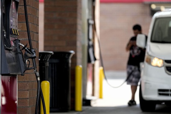 FILE - A person pumps gas, on Sept. 12, 2023, in Marietta, Ga. Oil prices have risen, meaning drivers are paying more for gasoline and truckers and farmers more for diesel. The increase also is complicating the global fight against inflation and feeding Russia's war chest to boot. 