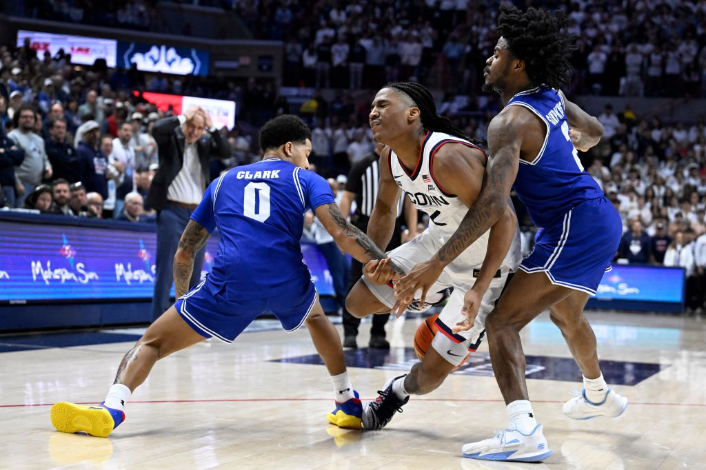 UConn guard Silas Demary Jr., center, loses the ball under pressures from Seton Hall guards Adam Clark, left, and Tajuan Simpkins, right, in the second half of an NCAA college basketball game, Saturday, Feb. 28, 2026, in Storrs, Conn.