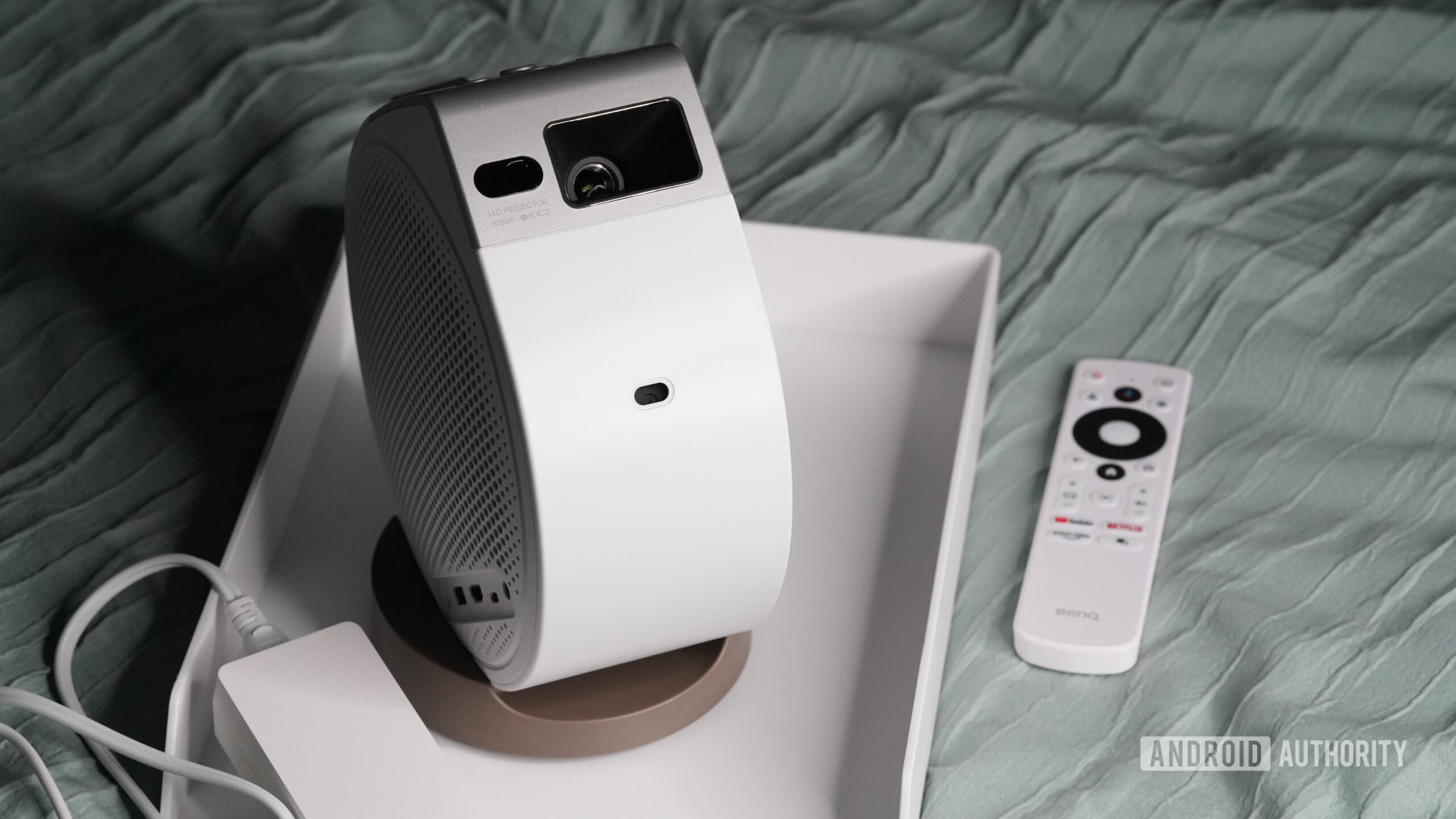 A BenQ GV32 rests on a users bed.