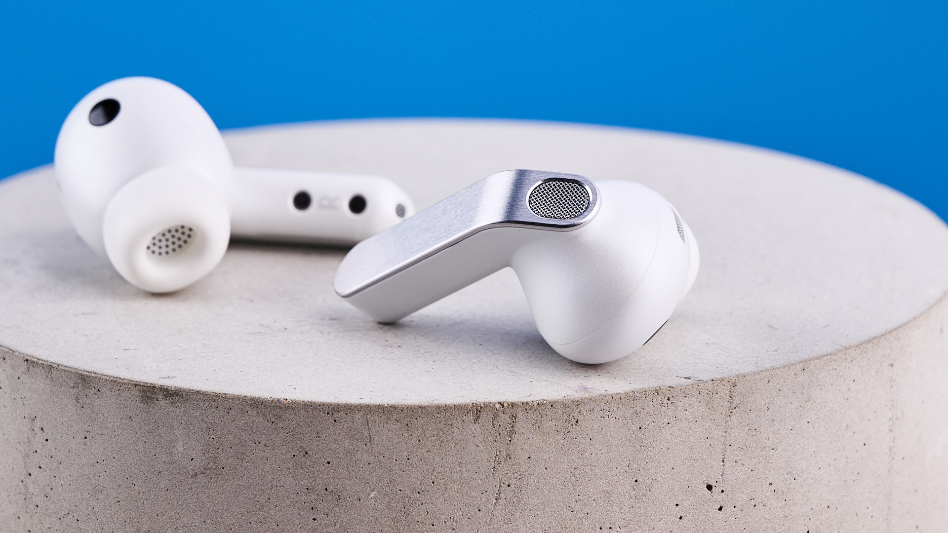 the samsung galaxy buds 4 pro in white photographed against the blue tom's guide background