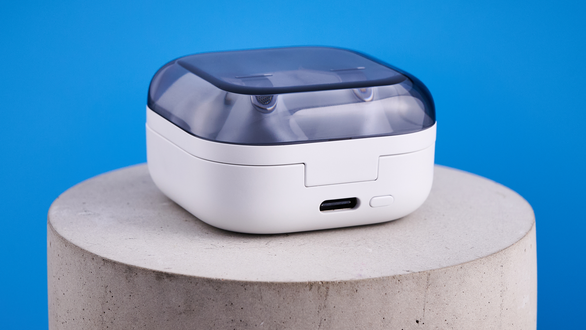 the samsung galaxy buds 4 pro in white photographed against the blue tom's guide background