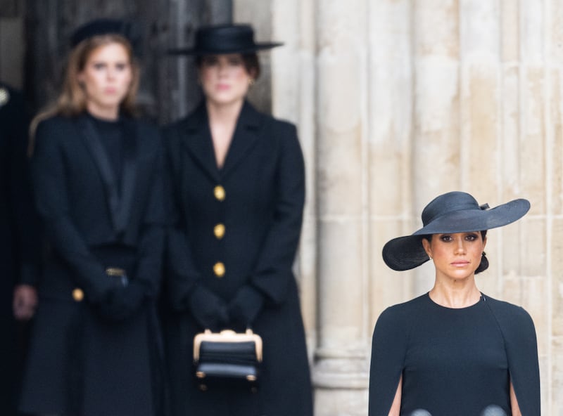 LONDON, ENGLAND - SEPTEMBER 19: Princess Beatrice of York, Princess Eugenie of York and Meghan, Duchess of Sussex during the State Funeral of Queen Elizabeth II at Westminster Abbey on September 19, 2022 in London, England. Elizabeth Alexandra Mary Windsor was born in Bruton Street, Mayfair, London on 21 April 1926. She married Prince Philip in 1947 and ascended the throne of the United Kingdom and Commonwealth on 6 February 1952 after the death of her Father, King George VI. Queen Elizabeth II died at Balmoral Castle in Scotland on September 8, 2022, and is succeeded by her eldest son, King Charles III. (Photo by Samir Hussein/WireImage)