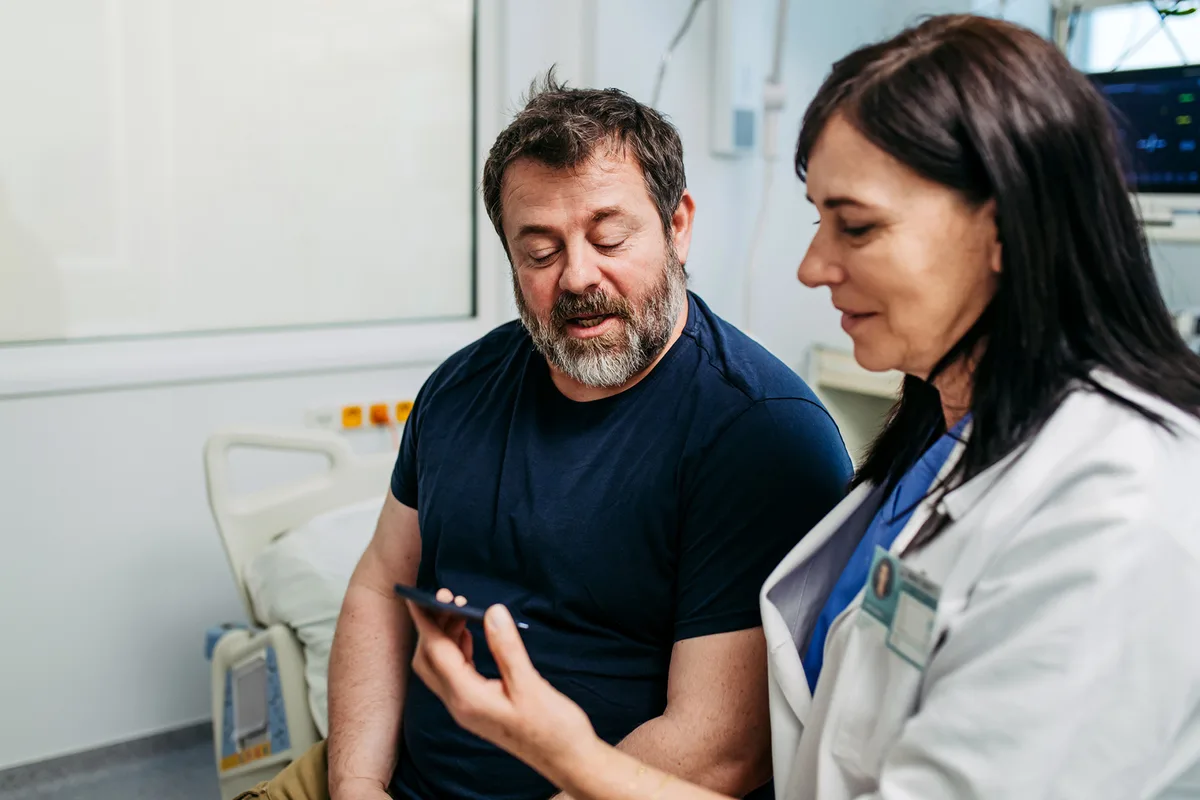 Doctor testing a man's blood sugar