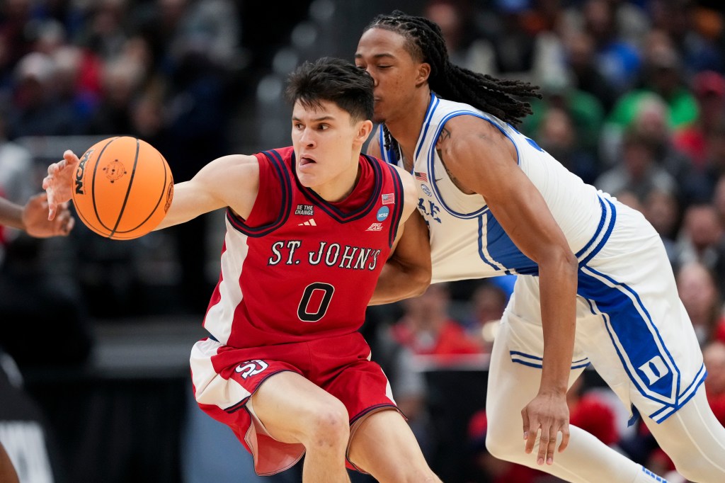 Dylan Darling reaches for a loose ball as Maliq Brown defends during St. John's Sweet 16 loss to Duke.