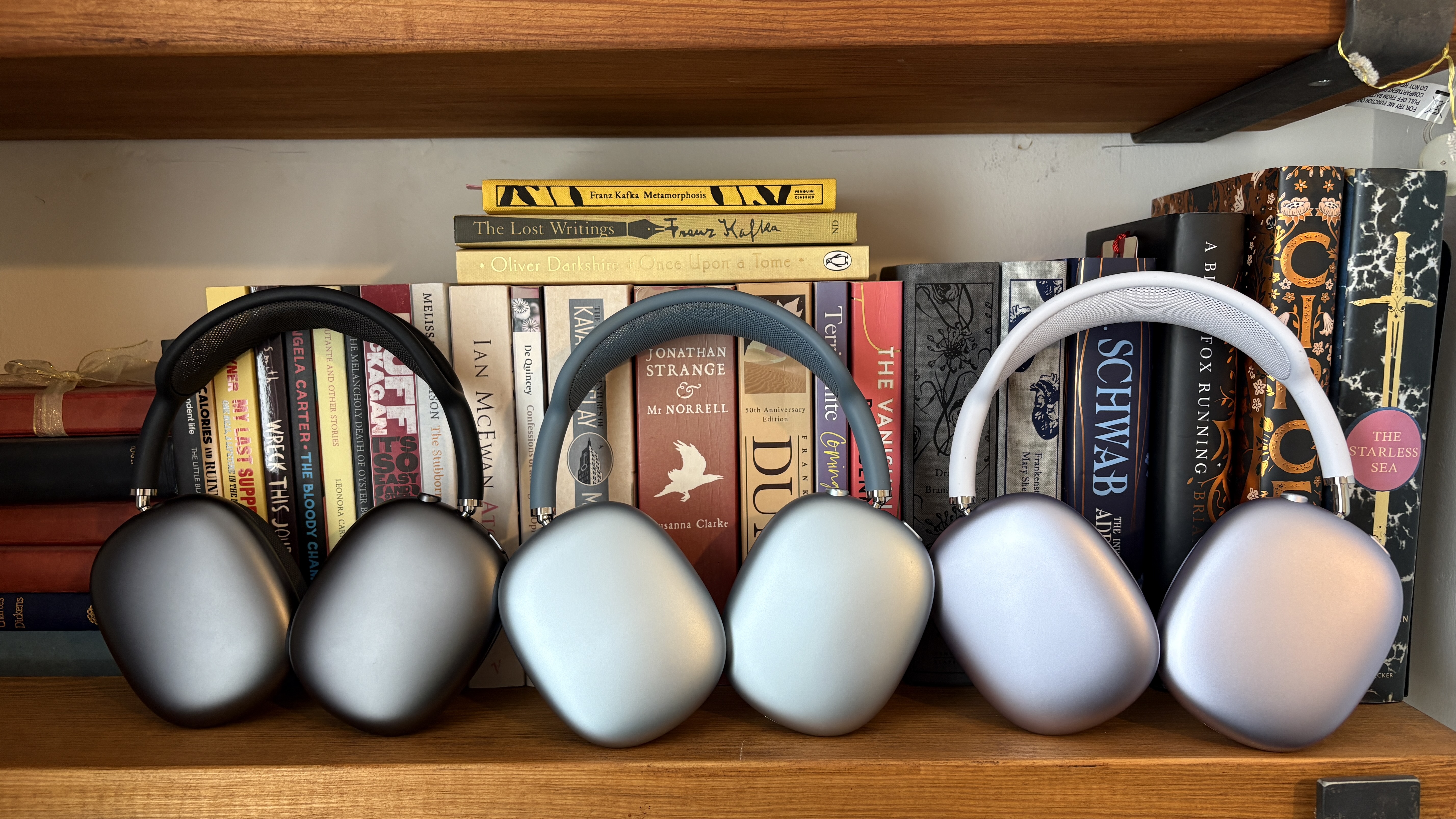 Three versions of AirPods Max, from left to right: original model with Lightning connector (2020), updated USB-C model (2024), new AirPods Max 2 (2026).