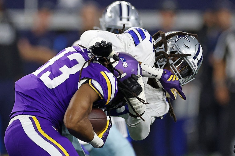 Former Dallas Cowboys defensive end Jadeveon Clowney brings down Minnesota Vikings running back Aaron Jones Sr. in Week 15.