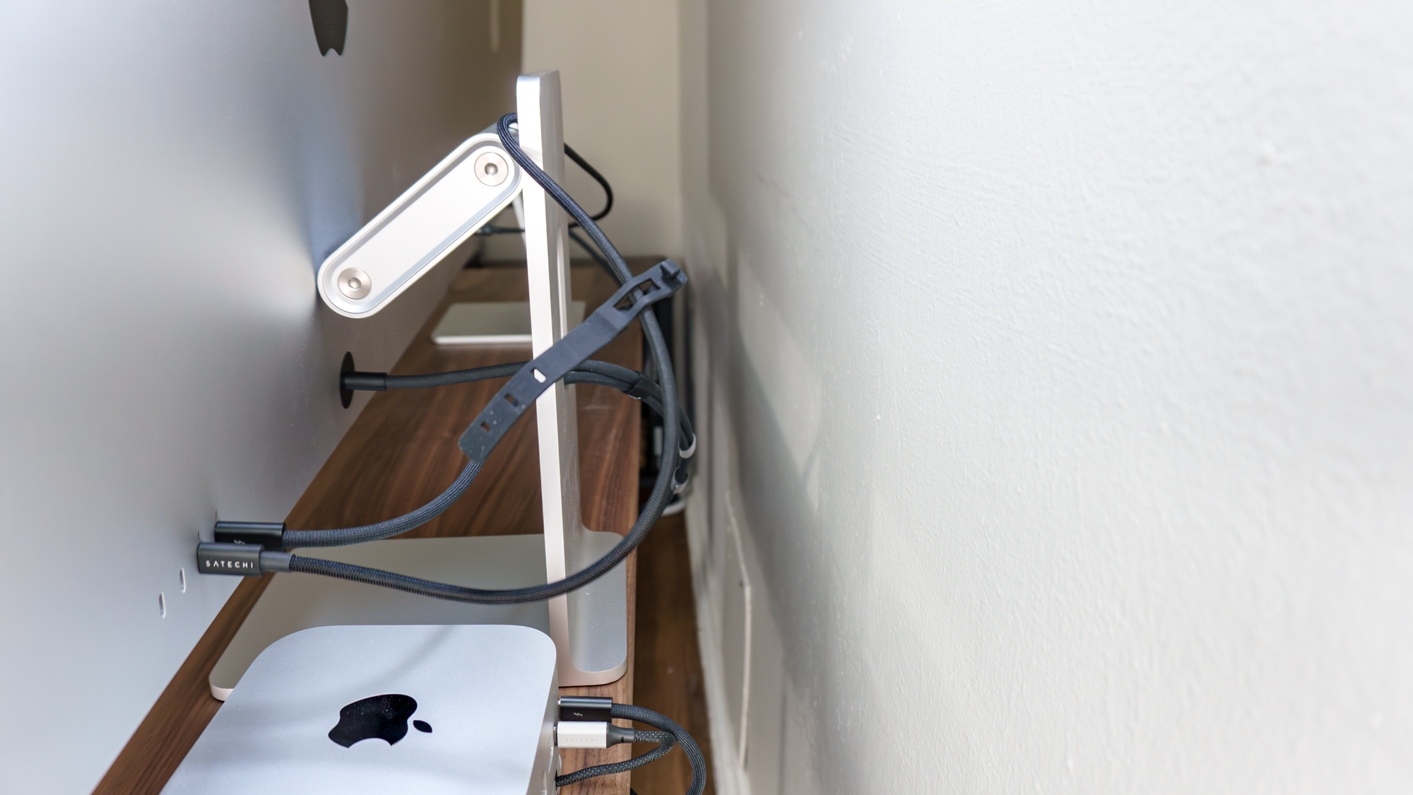 A rear shot showing a Studio Display connected to the Studio Display XDR via its downstream Thunderbolt 5 port