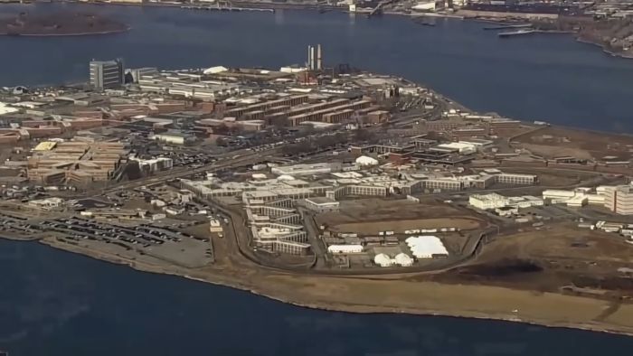 Aerial view of a large prison complex surrounded by water, relating to Harvey Weinstein lashing out from prison.