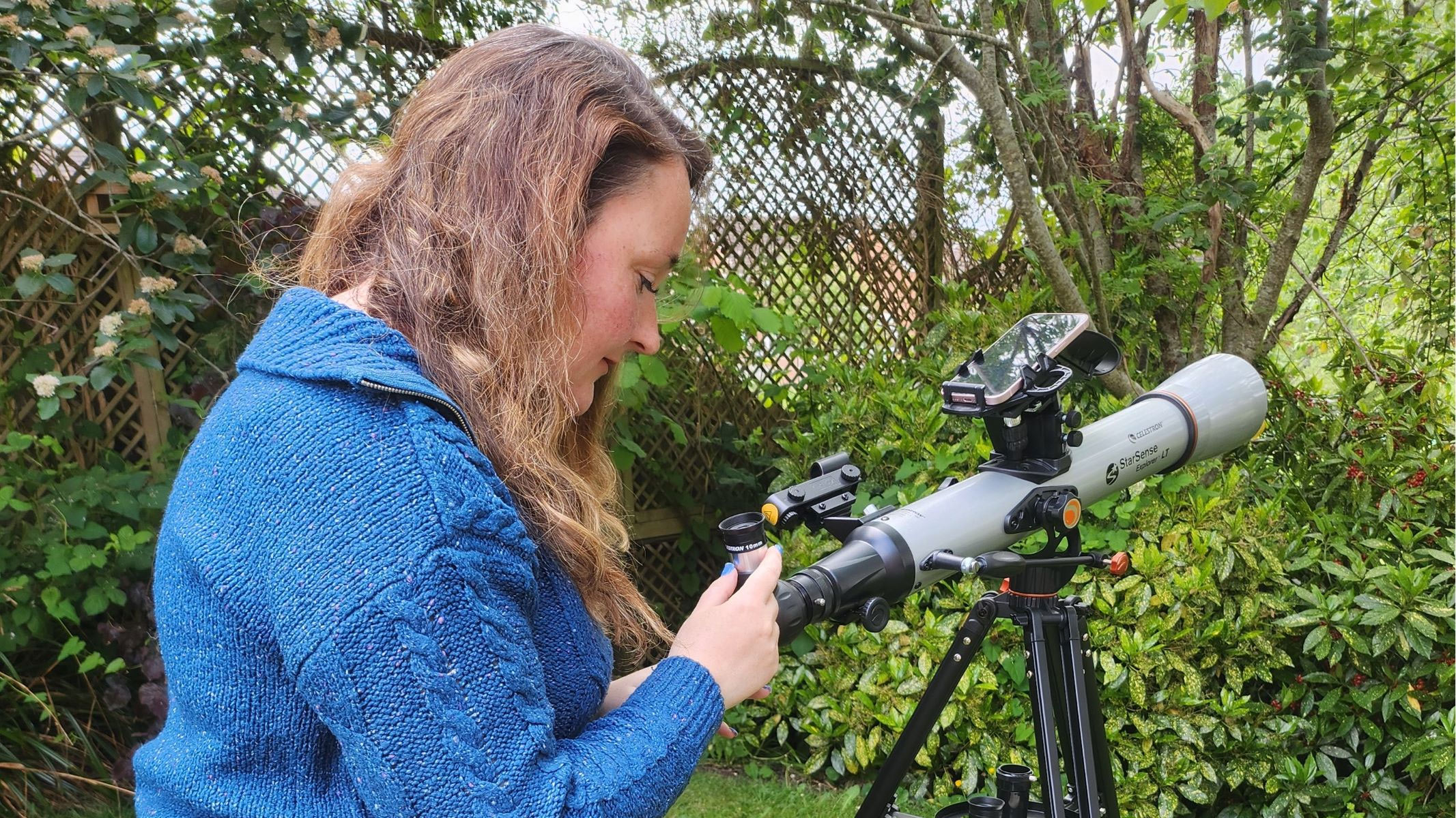 Our reviewer using the Celestron StarSense Explorer LT 70AZ.