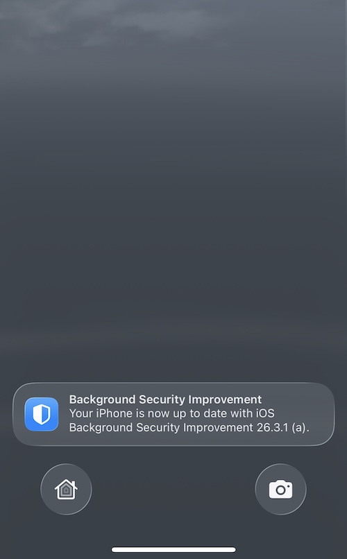 a screenshot showing an iPhone home/lock screen after a restart. A notification reads: "Background Security Improvement Your iPhone is now up to date with ioS Background Security Improvement 26.3.1 (a)."