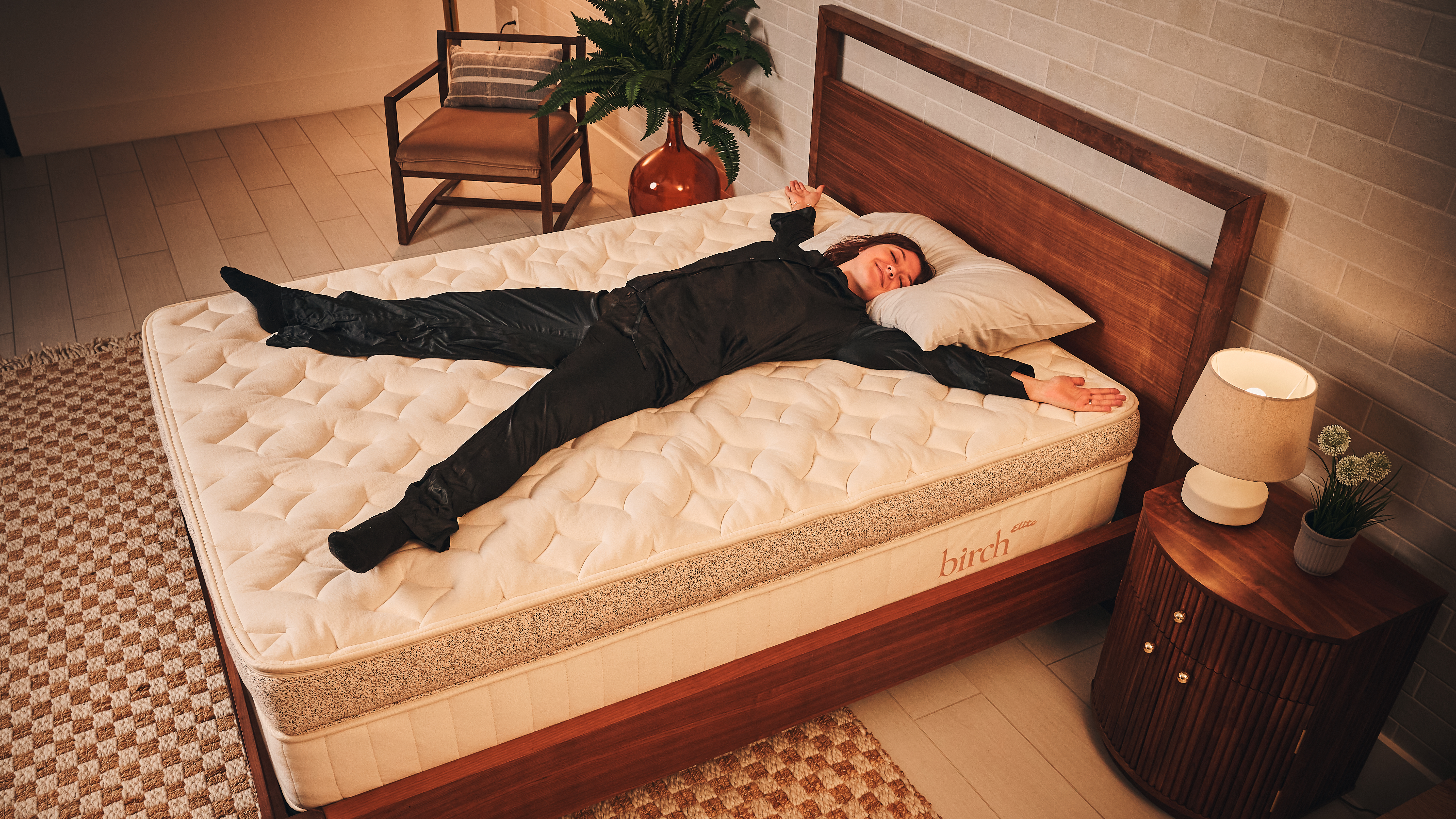 Tom's Guide Sleep Features Editor lying on her back like a starfish on the Birch Elite mattress that's discounted in the Black Friday mattress sales