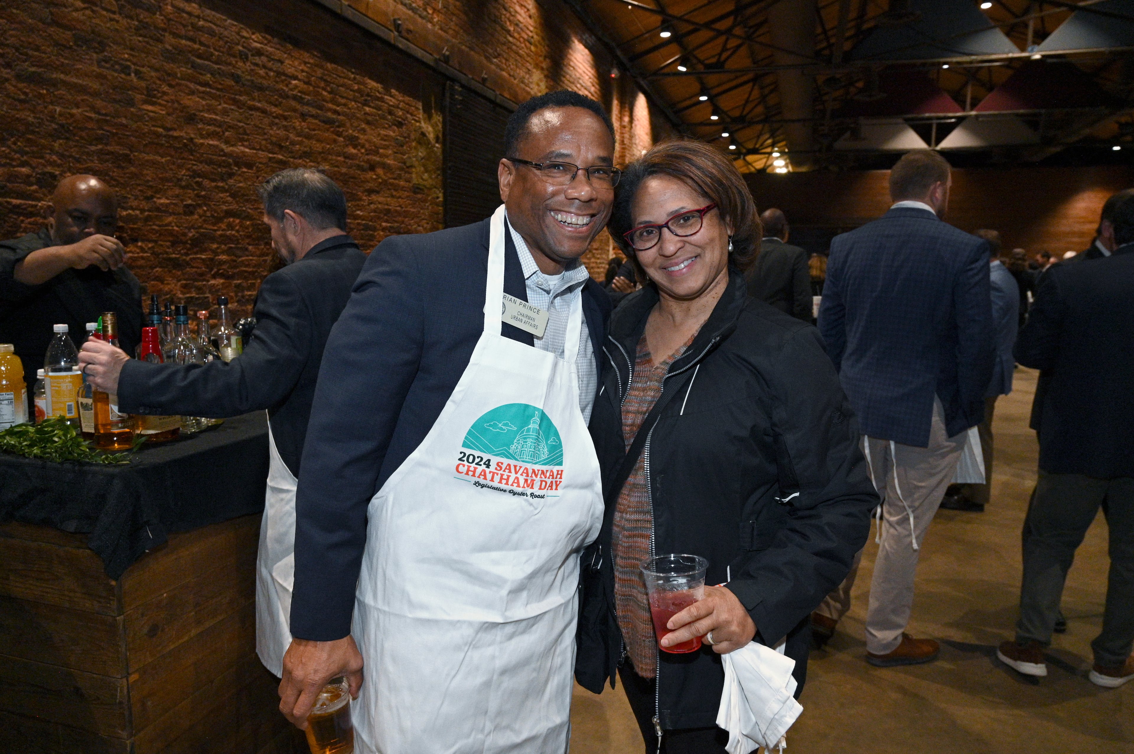 Rep. Brian Prince (left), D-Augusta, poses for a photo during Savannah-Chatham Day Legislative Oyster Roast at Georgia Freight Depot in 2024. (Hyosub Shin/AJC)
