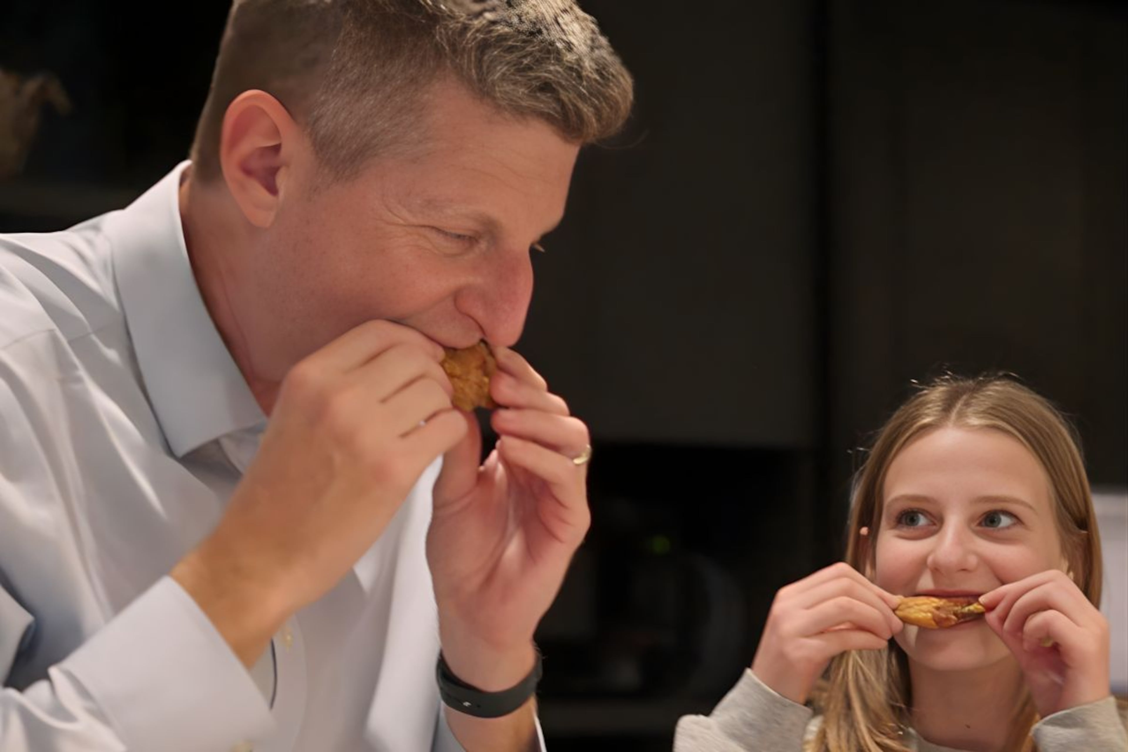 Greg Bluestein, chief political reporter for the AJC, and his daughter taste test wings to help find the best lemon pepper wings in Atlanta. (Matt Gannon/AJC)