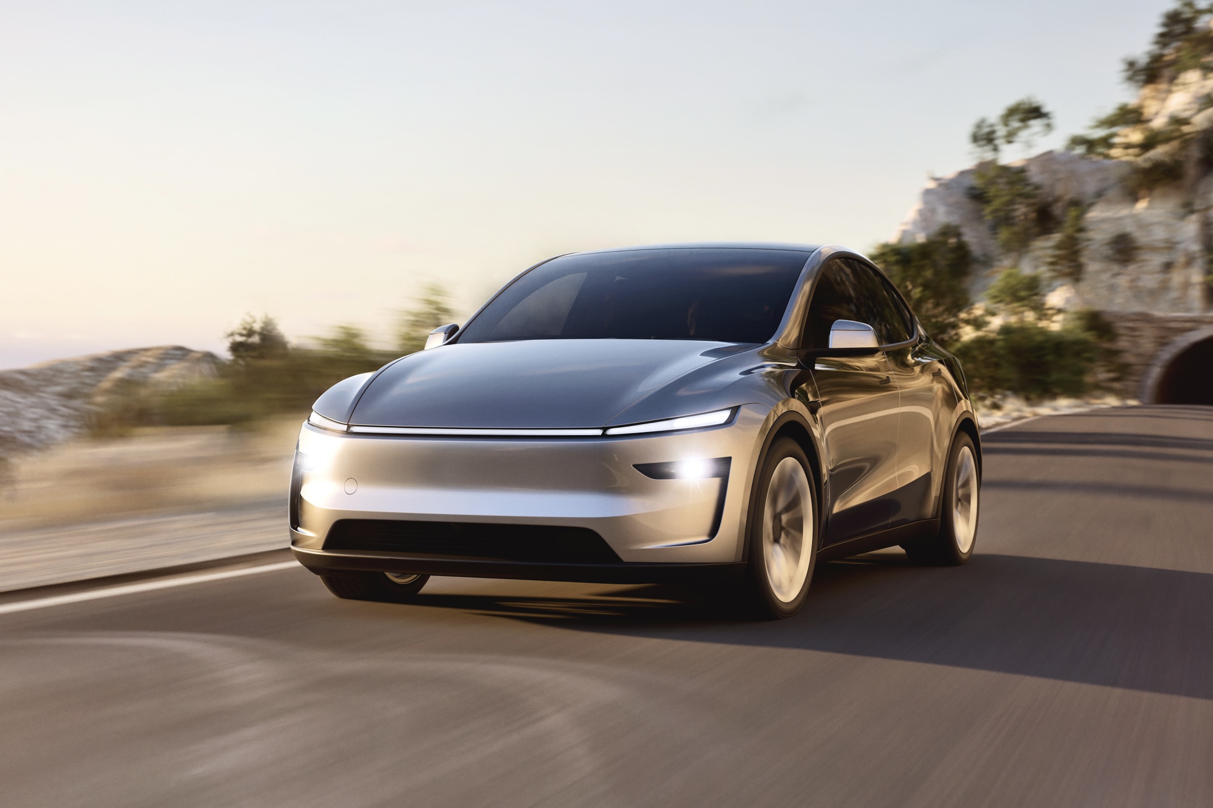 silver redesigned model Y driving towards camera