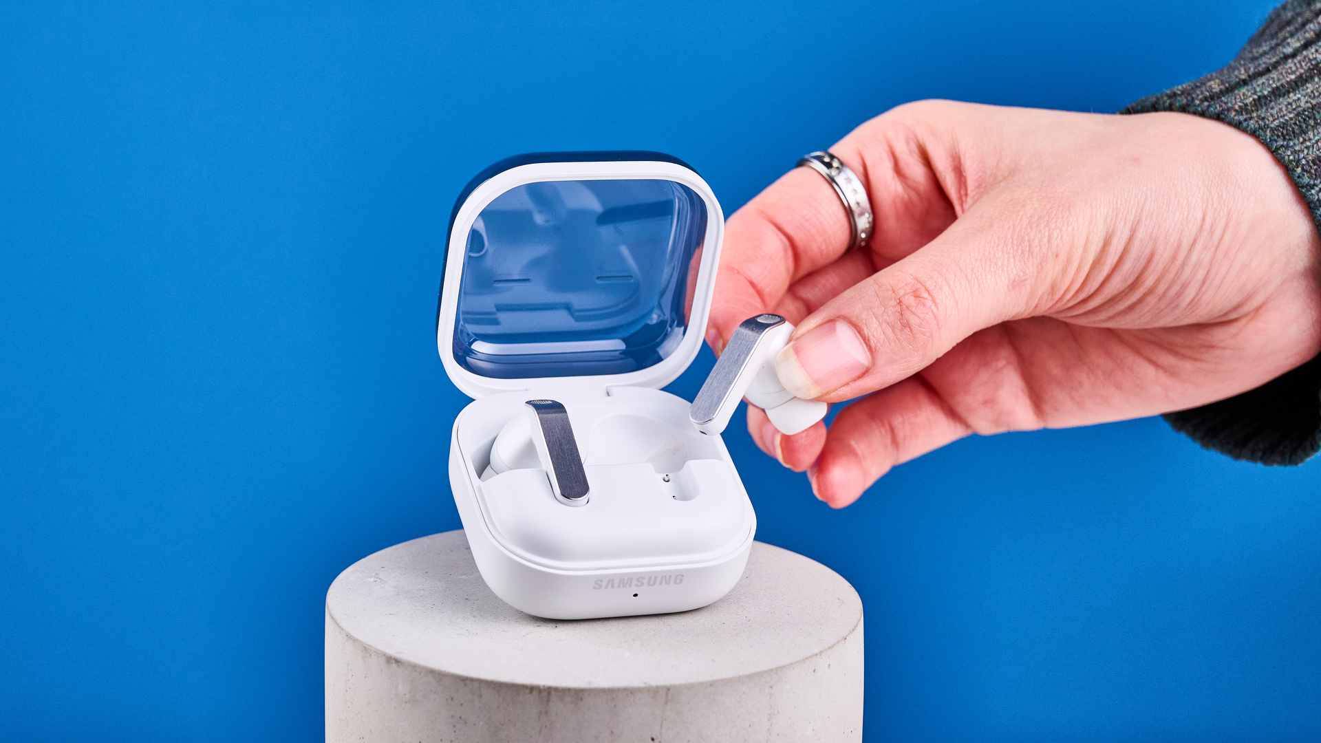 the samsung galaxy buds 4 pro in white photographed against the blue tom's guide background