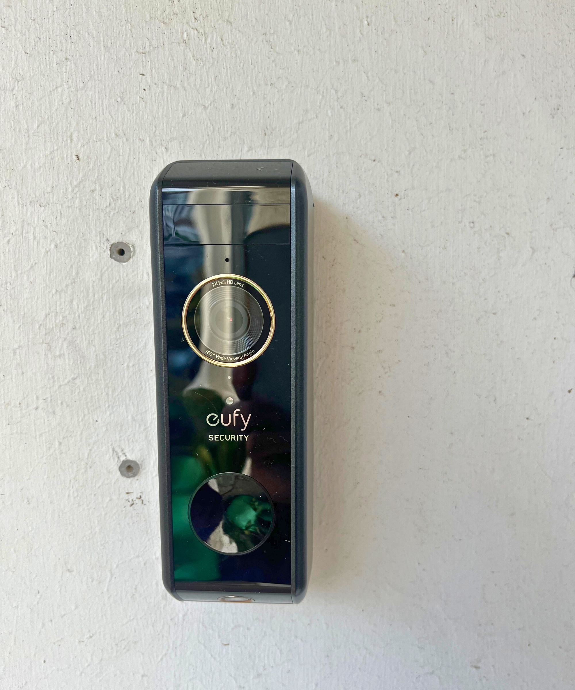 eufy S330 video doorbell mounted on white wall.
