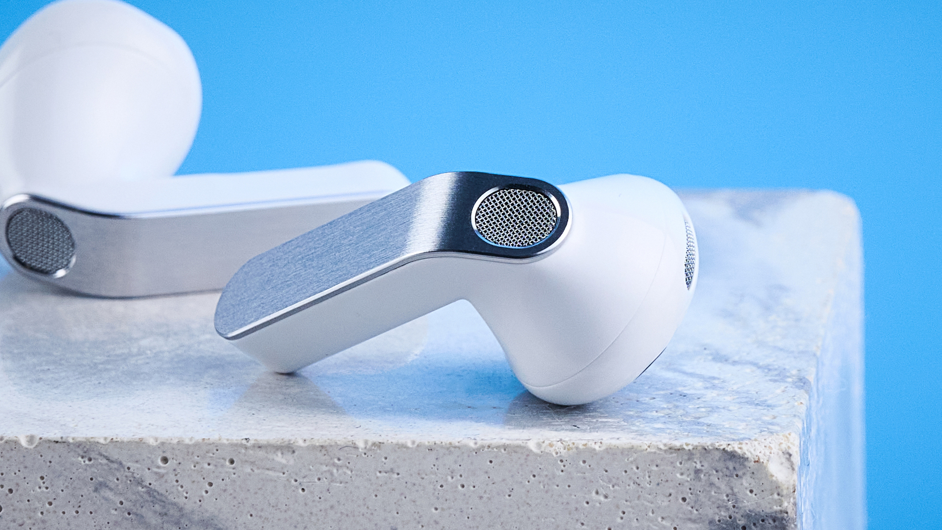 the samsung galaxy buds 4 photographed against the blue tom's guide background showing charging case and buds