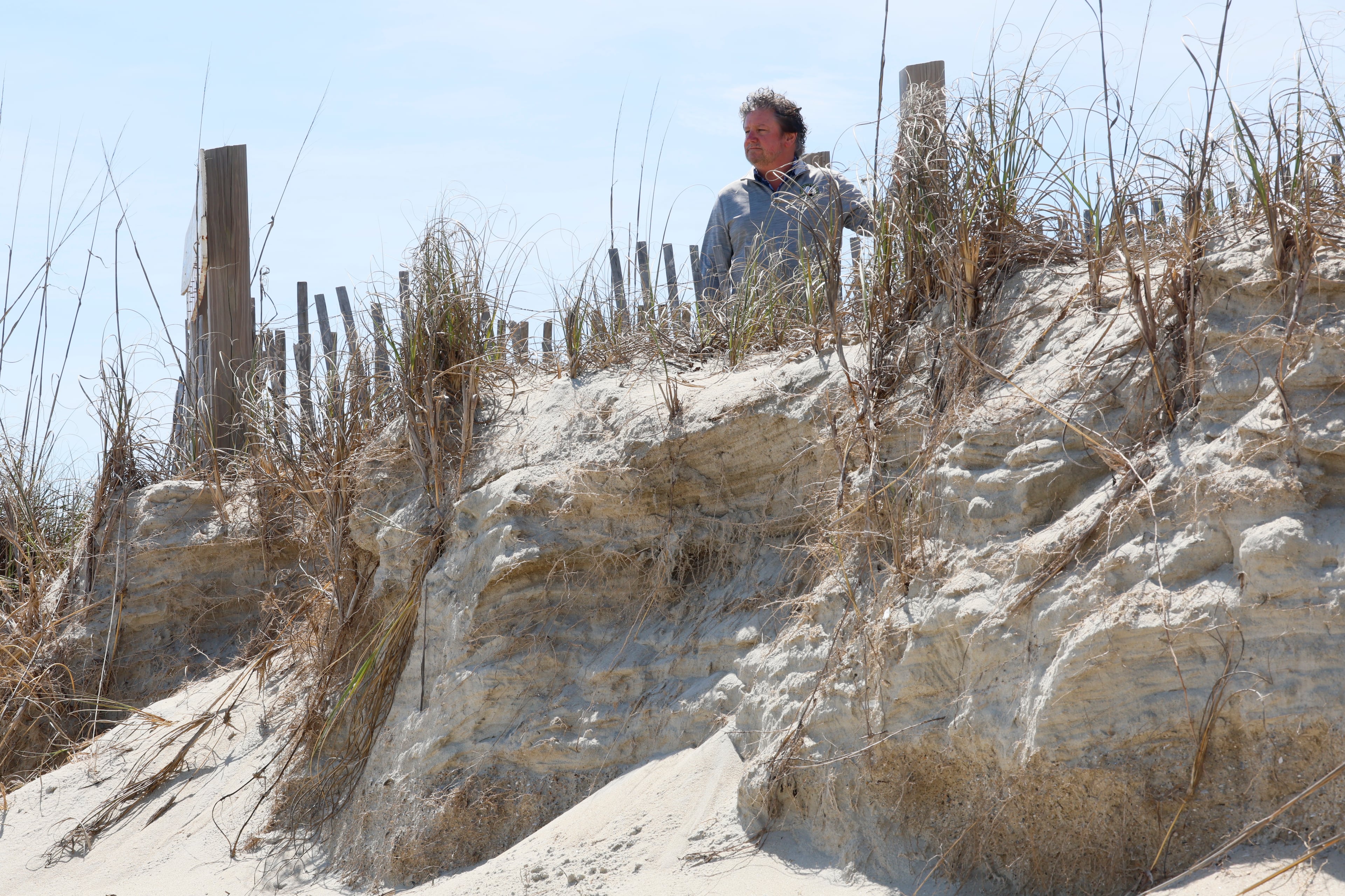 Tybee Island Mayor Brian West stands at the top of a blocked public access point at Mid Beach. (Miguel Martinez/AJC)