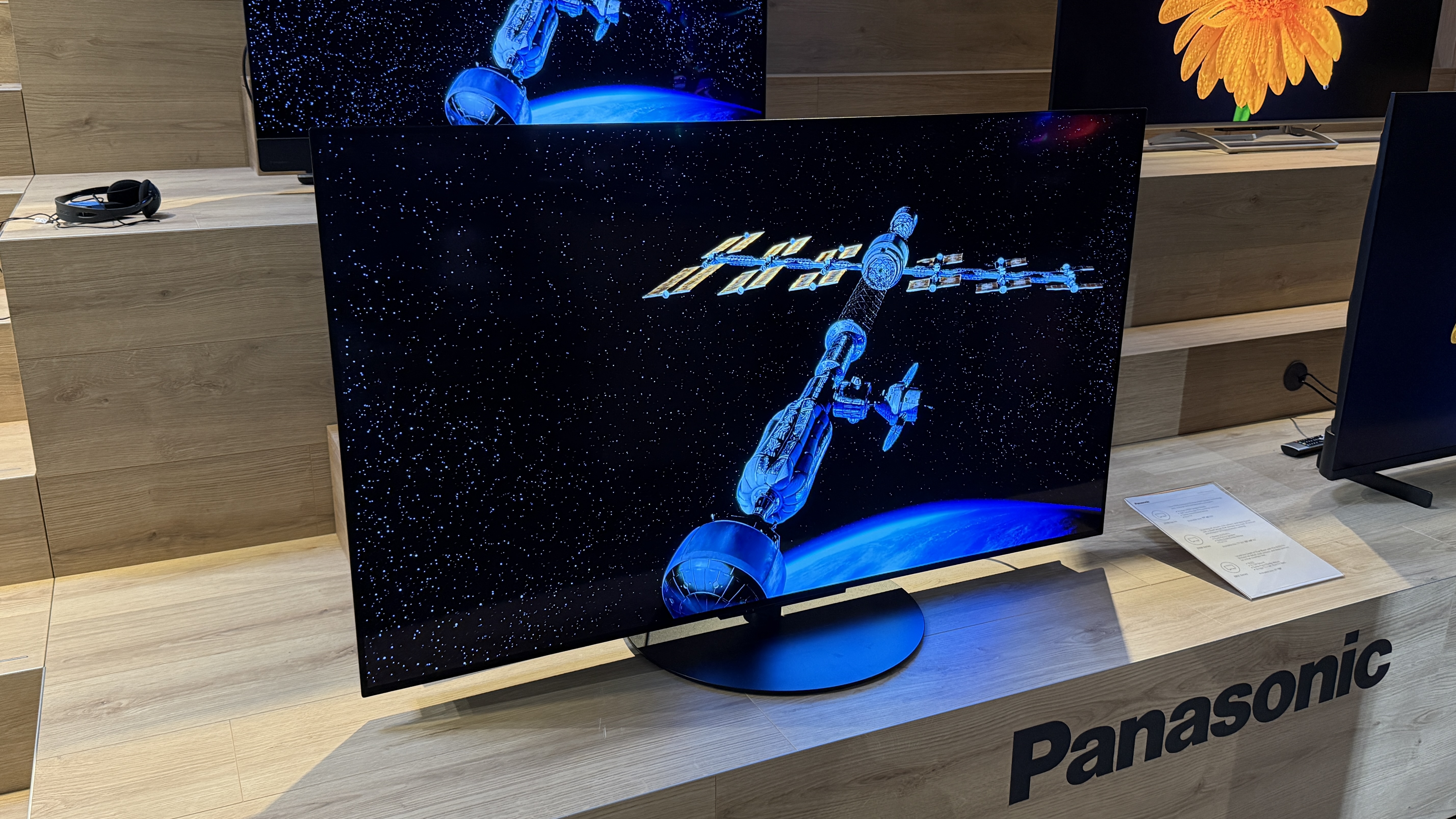 Panasonic Z85C with sci-fi images on screen sitting on a wooden tabletop