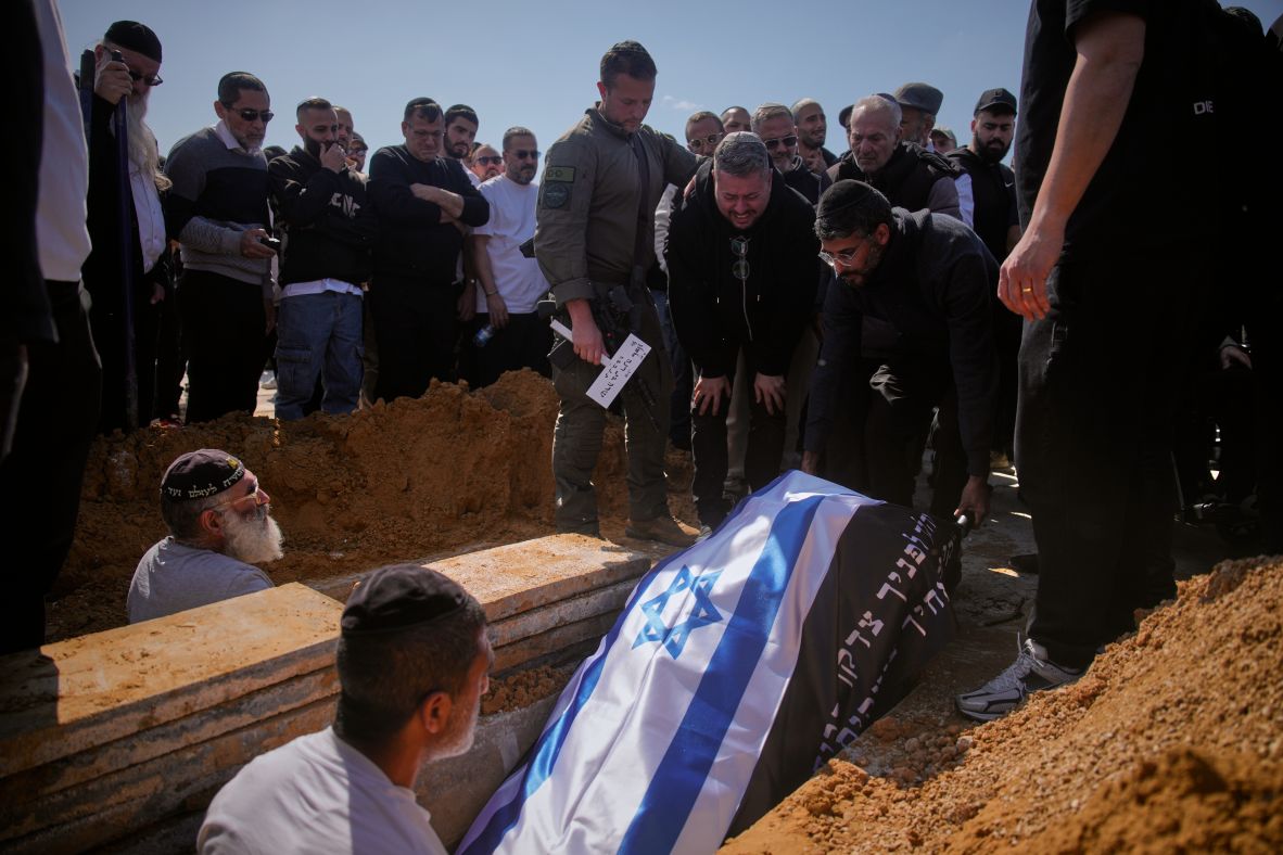 Mourners lower the flag-draped bodies of Sarah Elimelech and her daughter Ronit into a grave during their funeral in Beit Shemesh, Israel, on Monday, March 2. They were killed in an Iranian missile strike a day earlier.