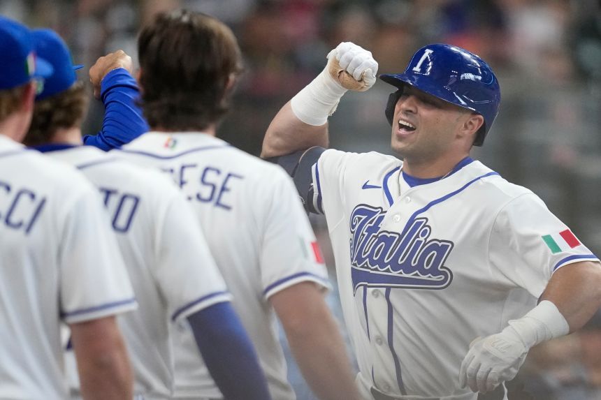 Team Italy's Dante Nori, right, celebrates his home run against Brazil on March 7.