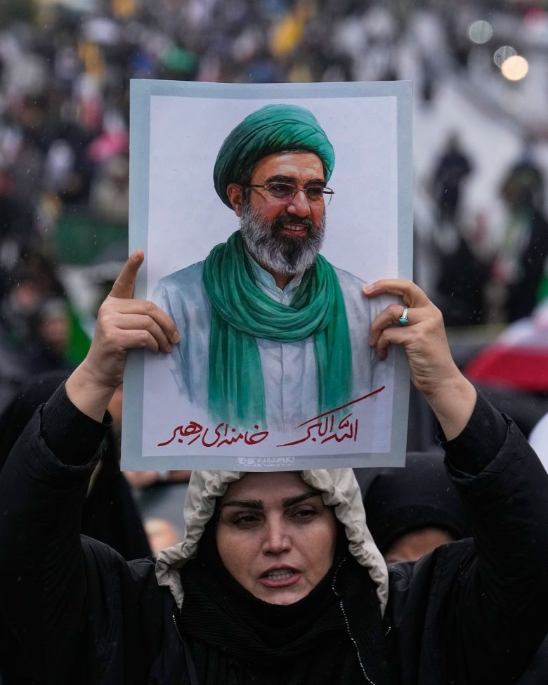 A woman holds up a poster of the Iranian Supreme Leader Ayatollah Mojtaba Khamenei during the annual Quds Day rally in support of Palestinians,  in Tehran, Iran, on March 13.