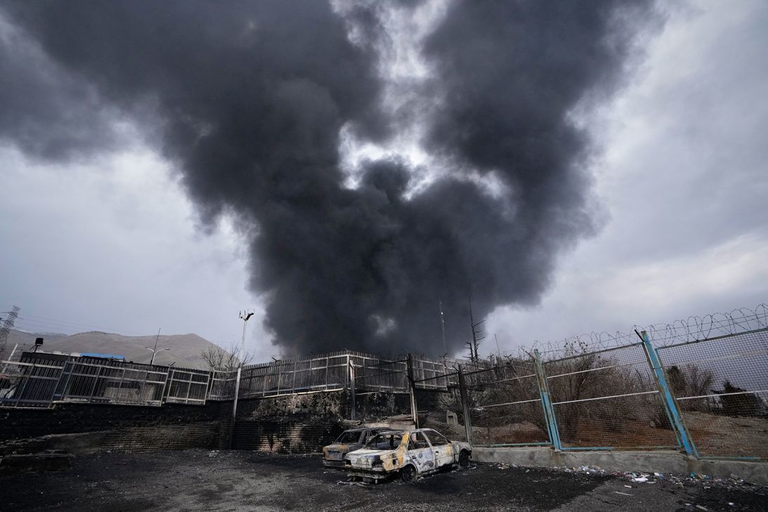 A thick plume of smoke rises from an oil storage facility hit by a US-Israeli strike in Tehran, Iran, on March 8.