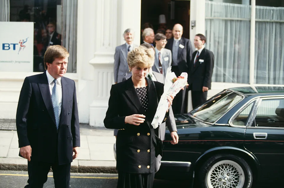 Ken Wharfe walking with Princess Diana next to a car