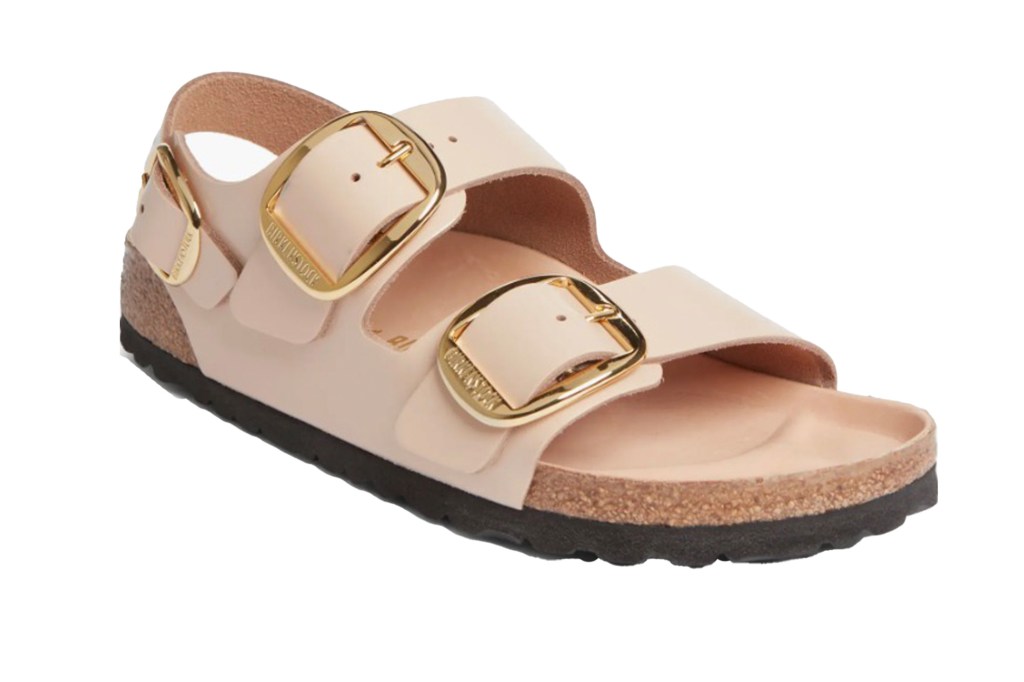 A light pink Birkenstock sandal with two gold buckles.