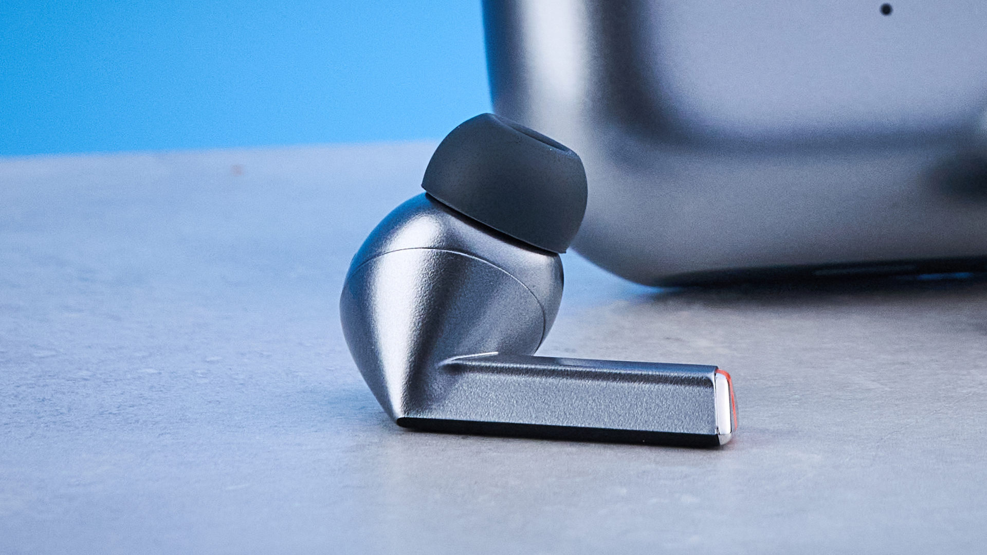 the samsung galaxy buds 3 pro photographed against the blue tom's guide background