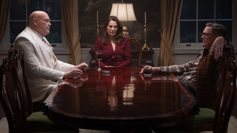 Vincent D'Onofrio as Wilson Fisk sitting at a table with Ayelet Zurer as Vanessa Fisk and Matthew Lillard as Mr. Charles in Daredevil: Born Again season 2