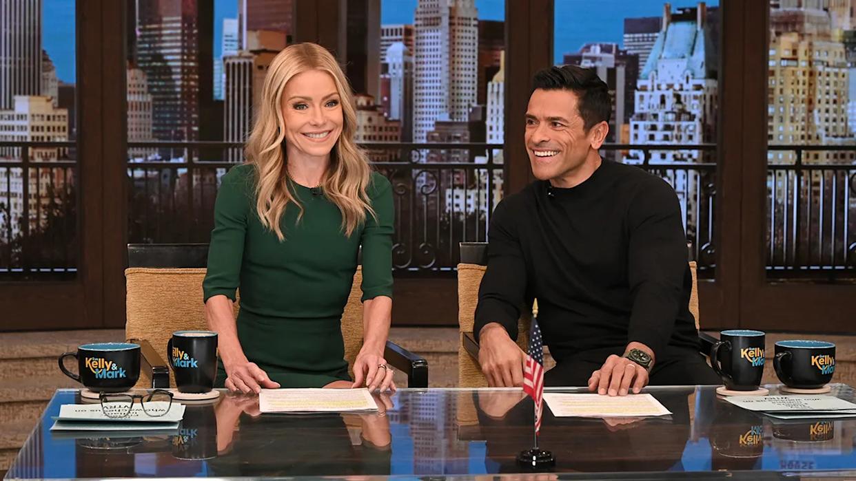 Kelly Ripa and Mark Consuelos wearing green and black on the "Live with Kelly and Mark" show.