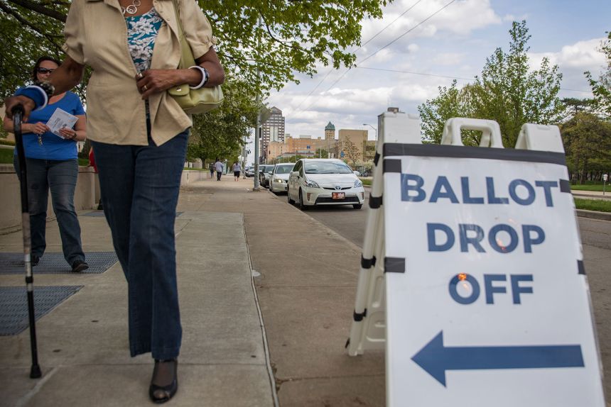 Ohio voters walk to drop off their ballots at the Board of Elections in Dayton, Ohio on April 28, 2020.