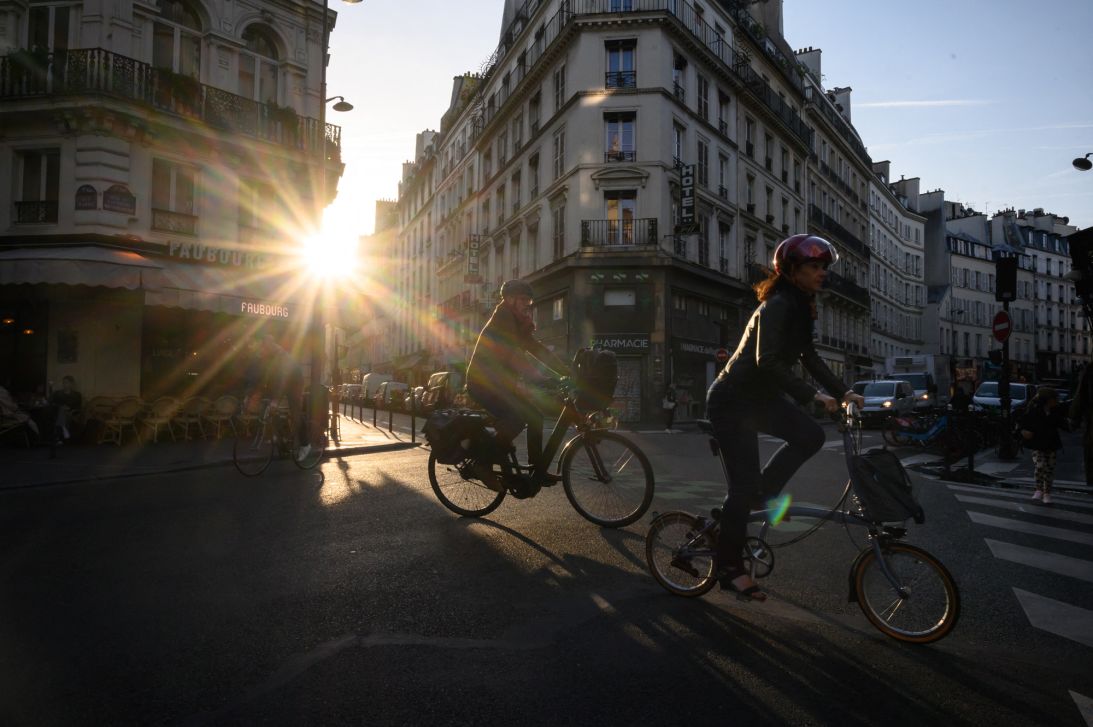 Commuters ride bicycles across an intersection in Paris on September 10, 2024. (Photo by Ed JONES / AFP) (Photo by ED JONES/AFP via Getty Images)