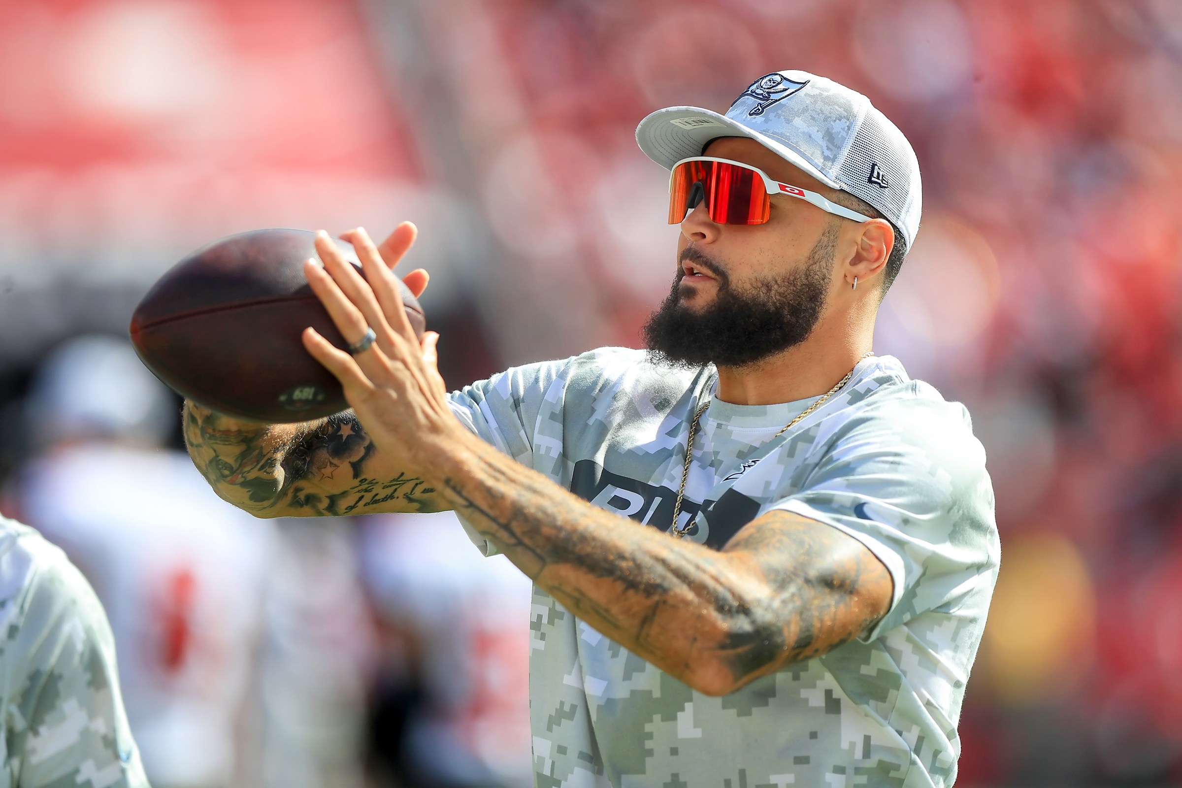 TAMPA, FL - NOVEMBER 10: Tampa Bay Buccaneers Wide Receiver Mike Evans (13) helps warm up a quarterback along the sidelines during the game between the San Francisco 49ers and the Tampa Bay Buccaneers on November 10, 2024 at Raymond James Stadium in Tampa, Florida. (Photo by Cliff Welch/Icon Sportswire via Getty Images)