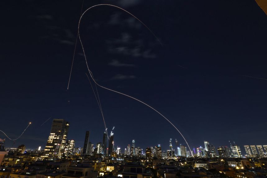 Rocket trails from an interception by Israel's Iron Dome missile defense system are pictured over Tel Aviv on March 1, 2026.