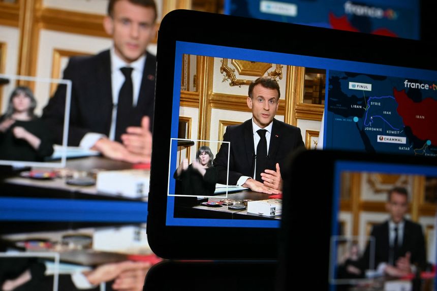 This photograph taken in Mulhouse, eastern France, shows screens broadcasting French President Emmanuel Macron's address regarding the war with Iran.
