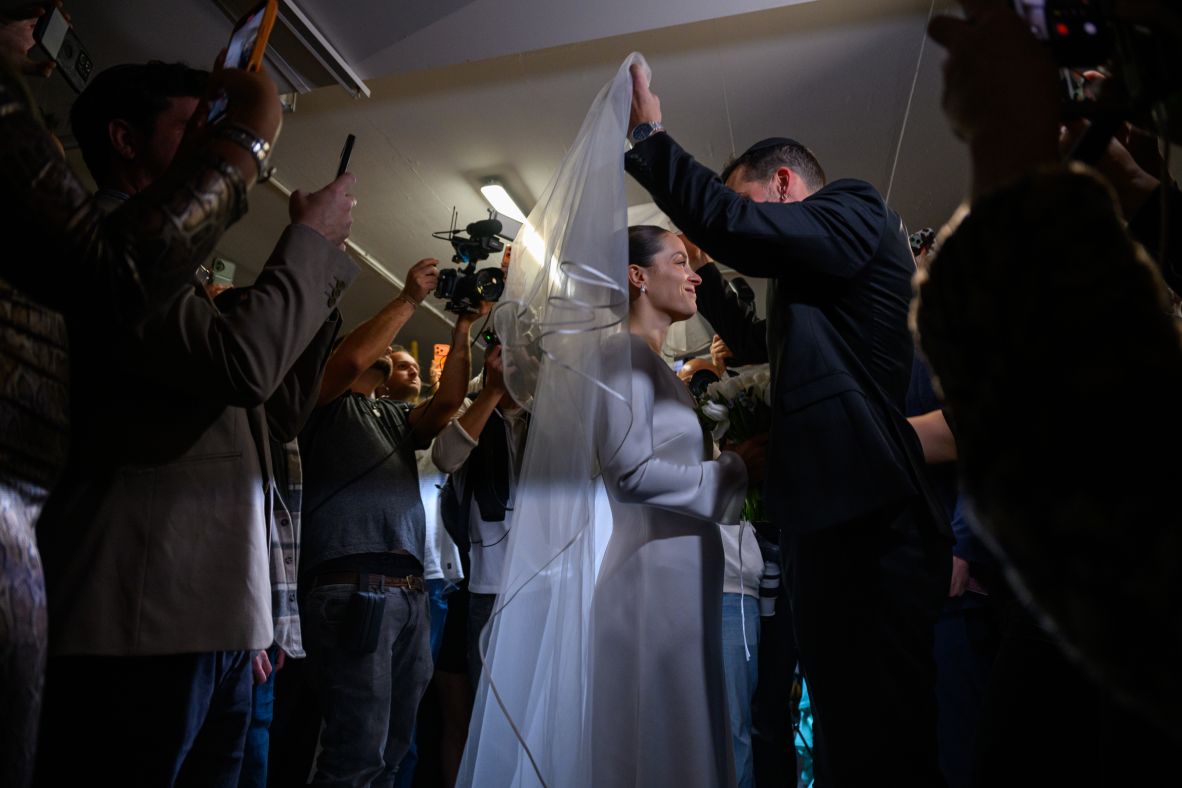 A man named Misha puts the veil over the face of his bride, Lior, while getting married in an underground bomb shelter in Tel Aviv, Israel, on Tuesday. The wedding was originally meant to take place in Petah Tikva, but it was moved to the bomb shelter because of the war.