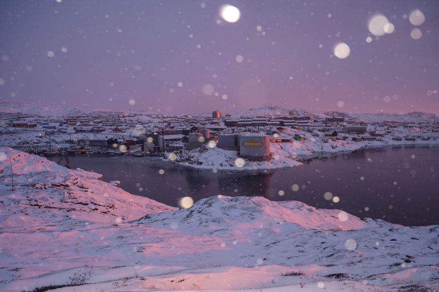 Snow falls over the city of Ilulissat, Greenland