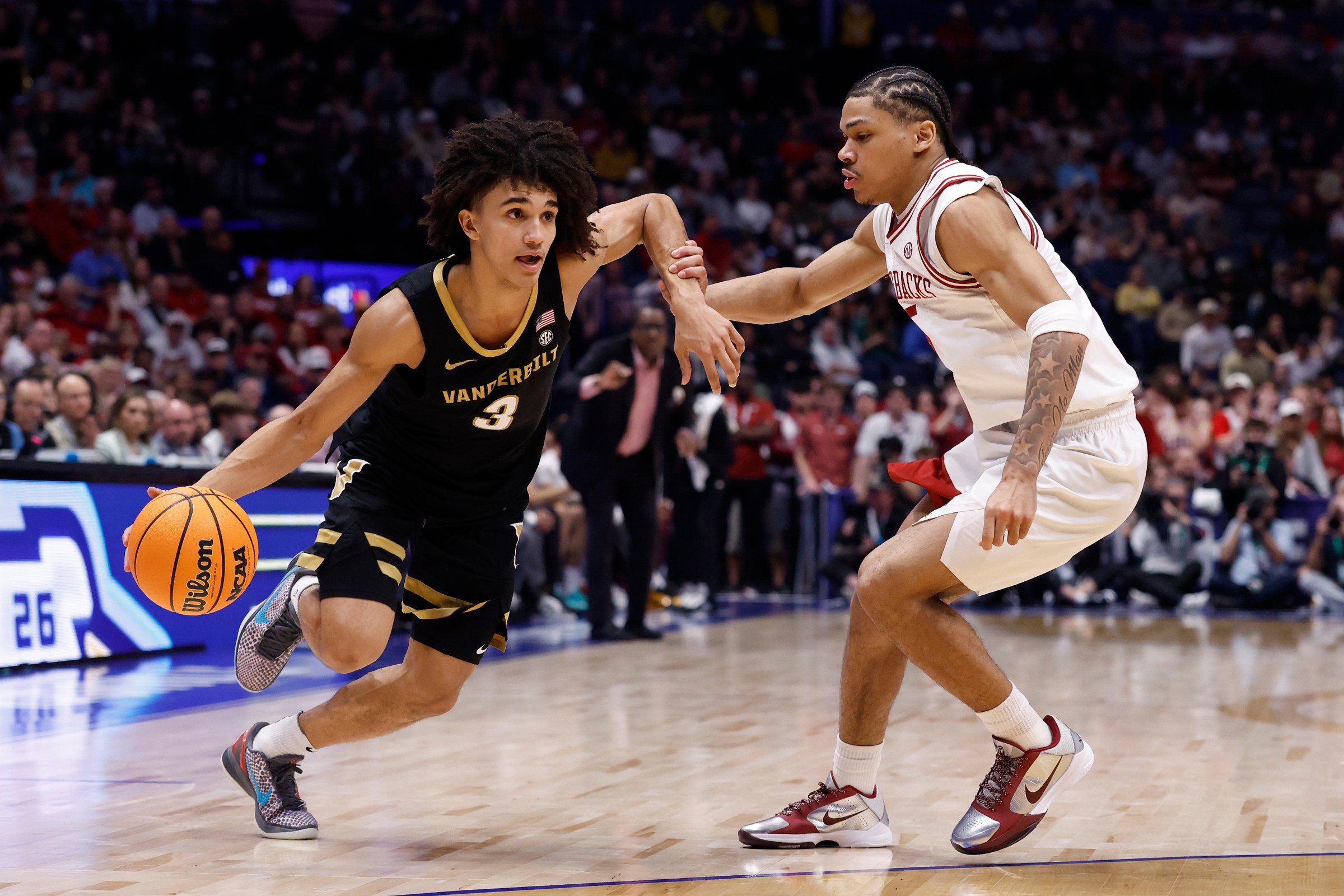 NASHVILLE, TENNESSEE - MARCH 15: Tyler Tanner #3 of the Vanderbilt Commodores drives around Darius Acuff Jr. #5 of the Arkansas Razorbacks in the second half of 2026 SEC Men’s Basketball Tournament Championship game at Bridgestone Arena on March 15, 2026 in Nashville, Tennessee. (Photo by Johnnie Izquierdo/Getty Images)