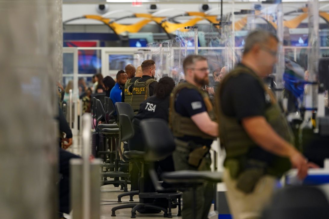 ICE agents check IDs at a security checkpoint in Atlanta Hartsfield-Jackson International Airport on Thursday.