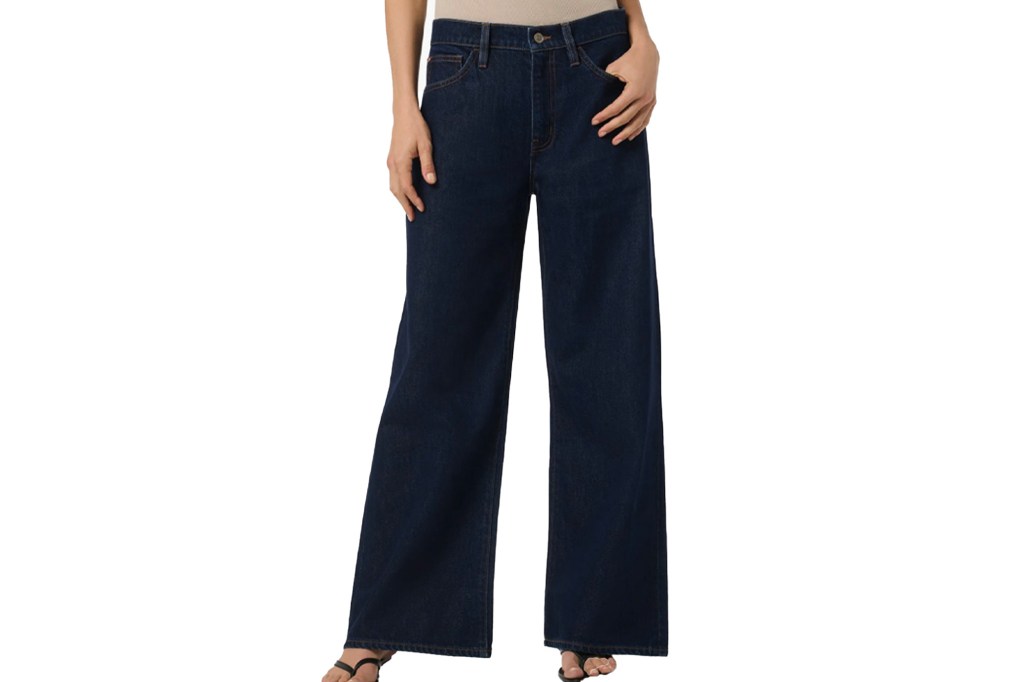 A woman wearing dark wash wide-leg jeans.