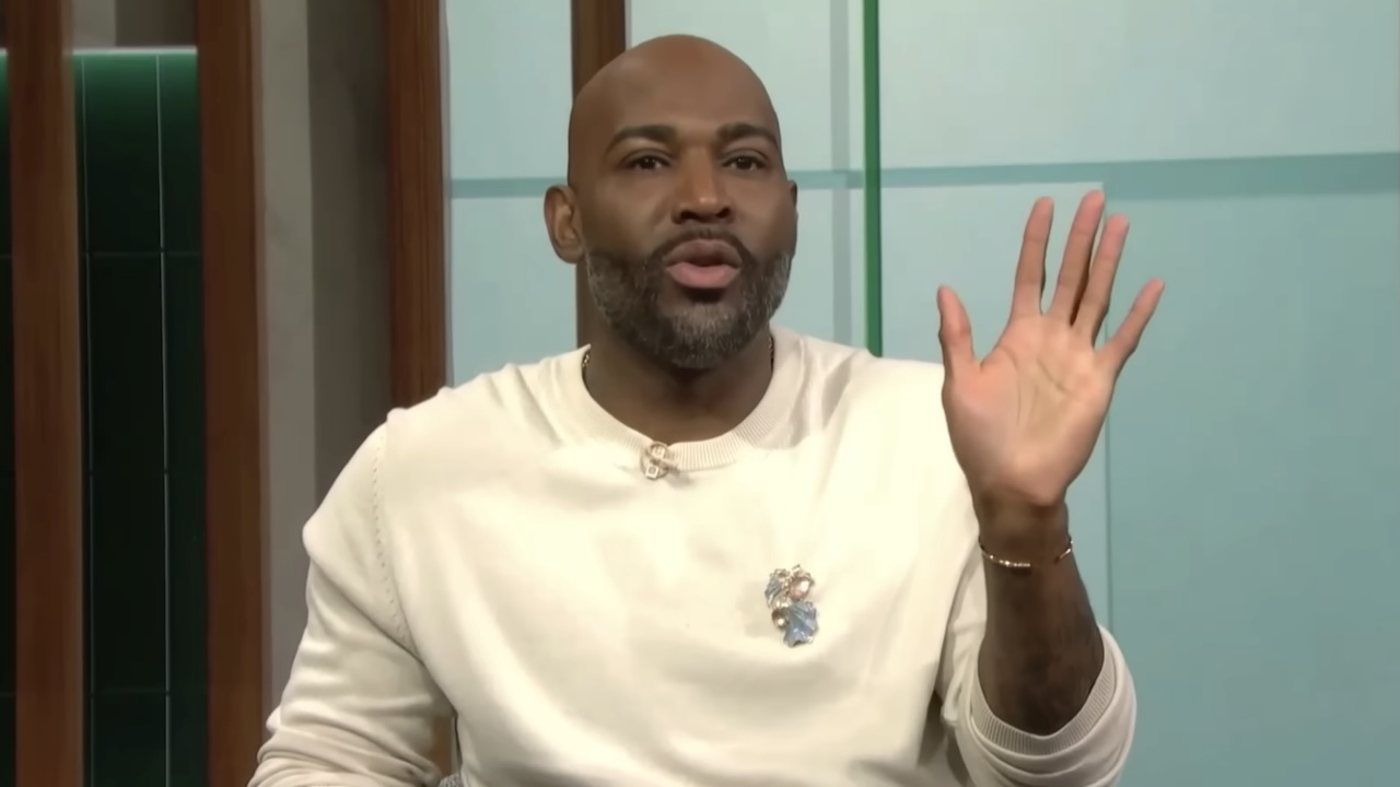 Karamo Brown holding hand up talking to audience member on Karamo