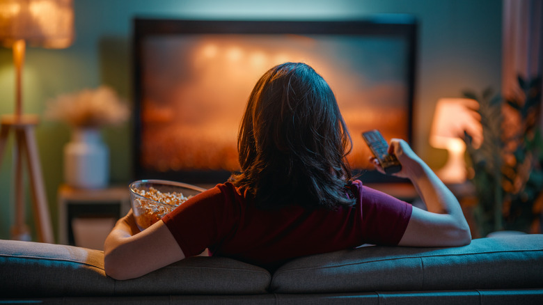 Person watching TV on a couch