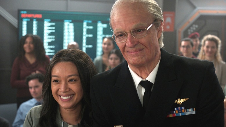 Ed and Kelly Baldwin smiling during a ceremony on Mars in For All Mankind
